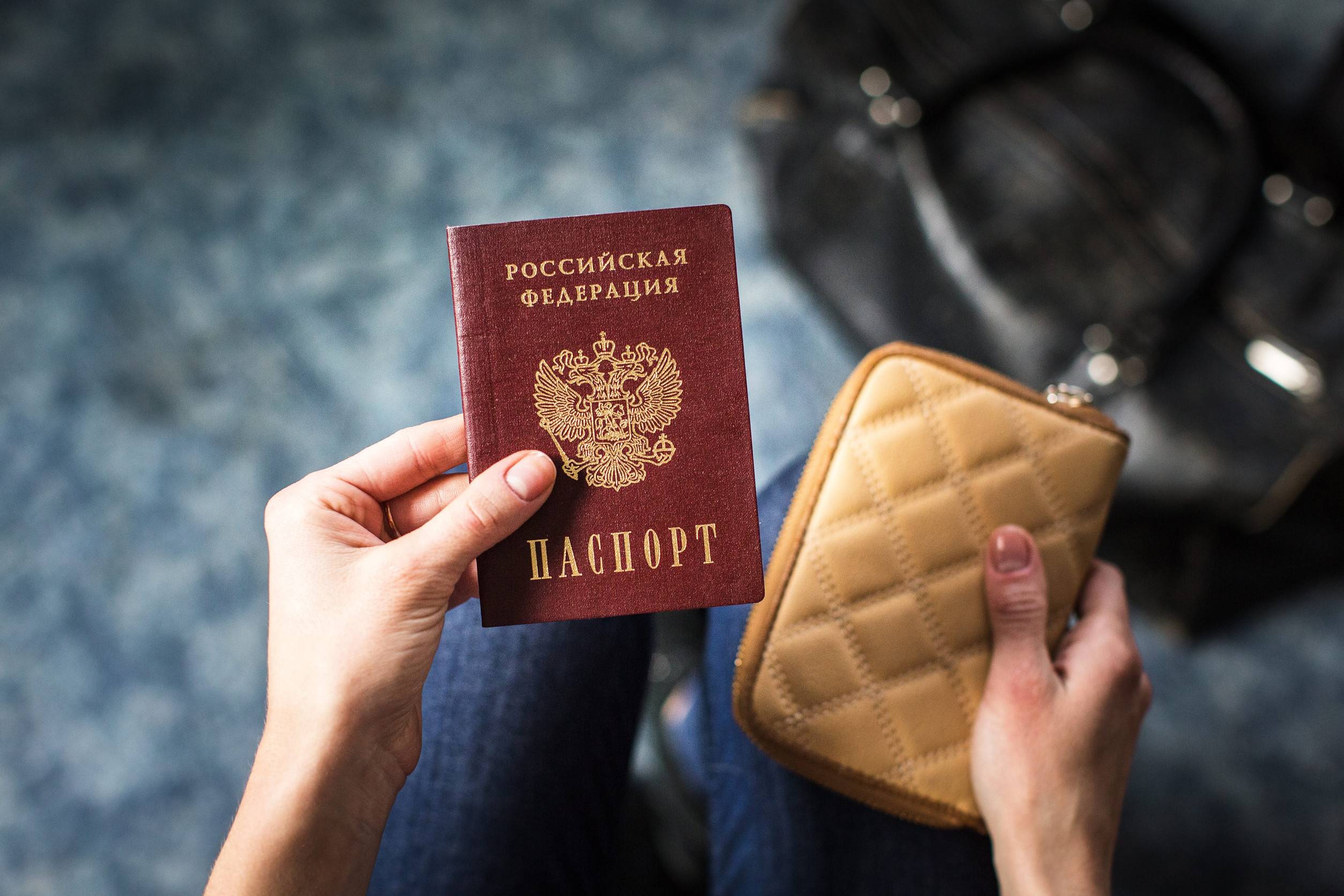 A Girl holding the Russian passport and wallet