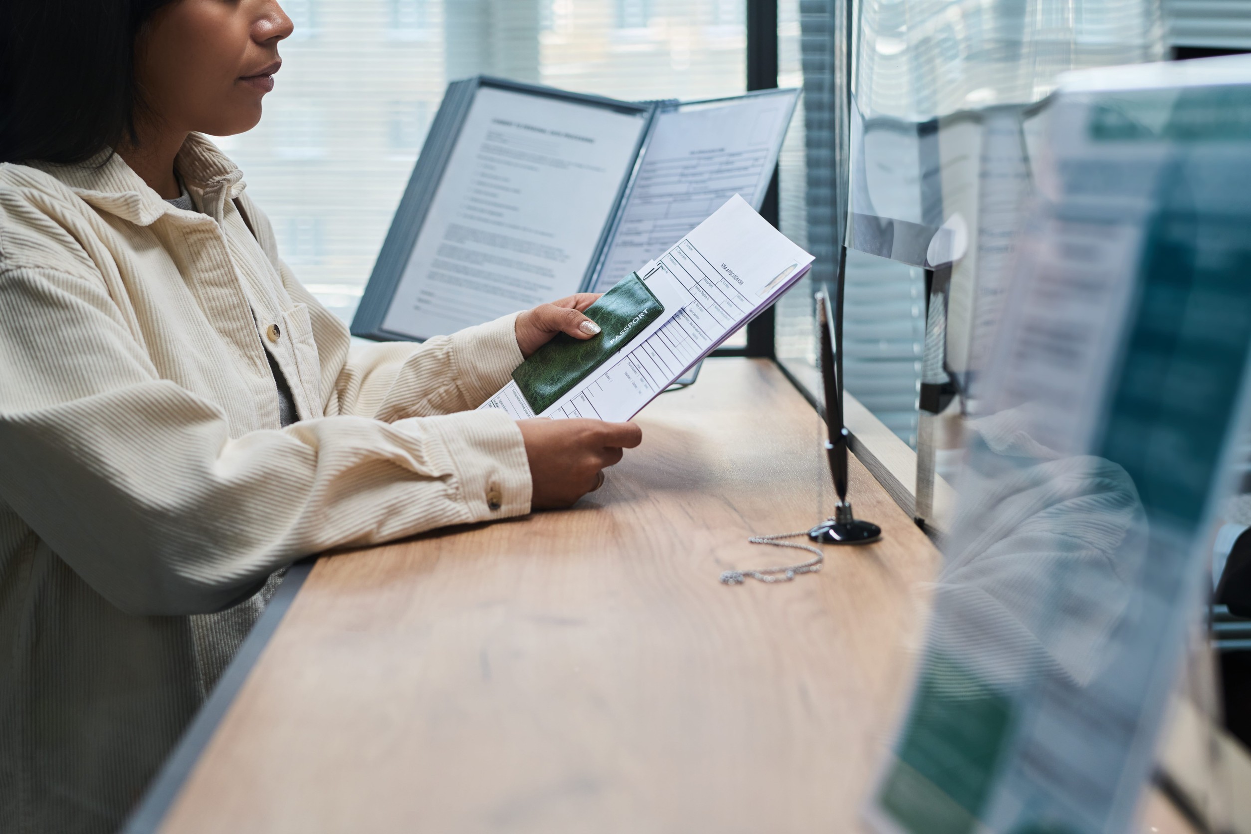Applicant at an immigration counter desk