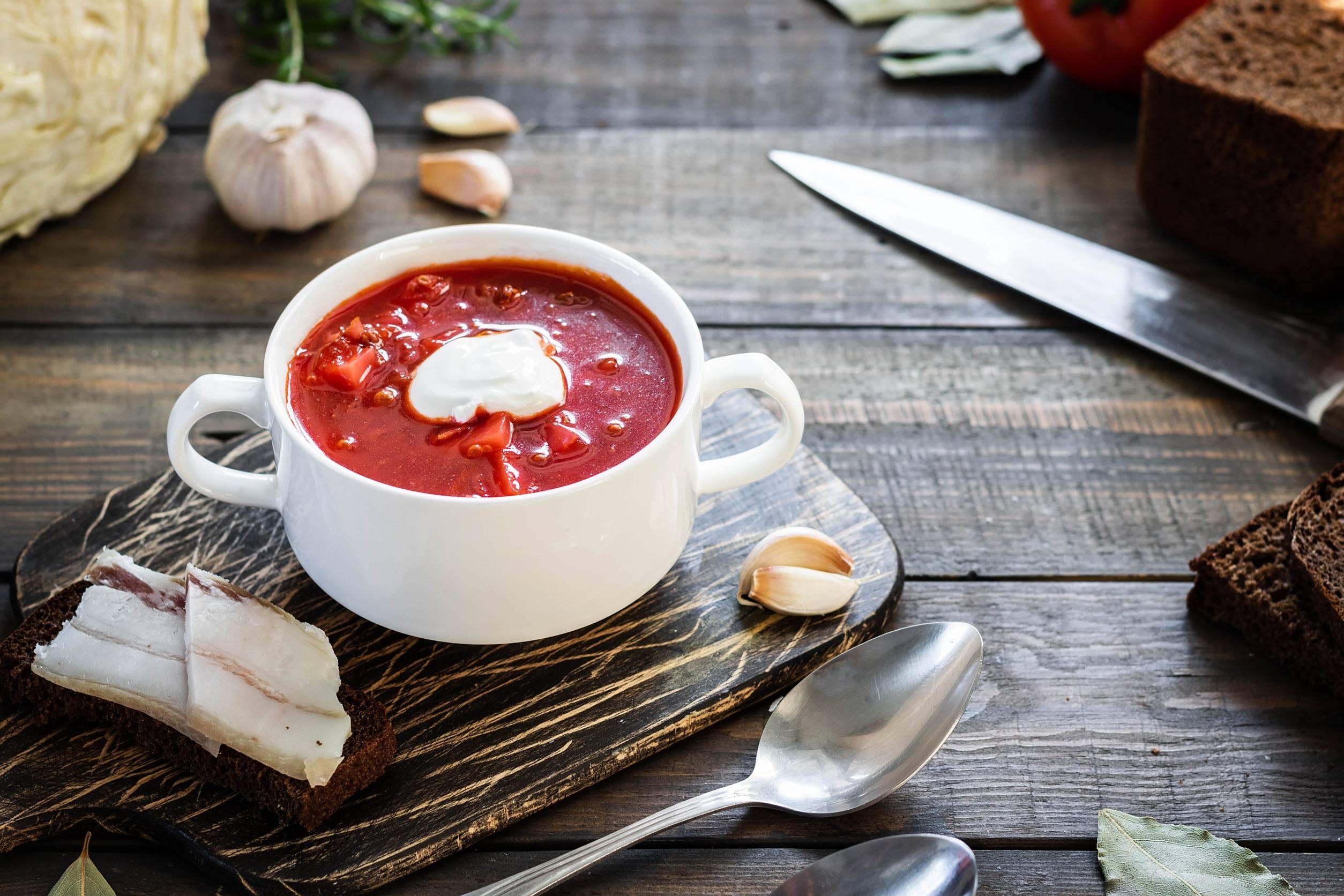 Borscht in a soup bowl with pieces of meat