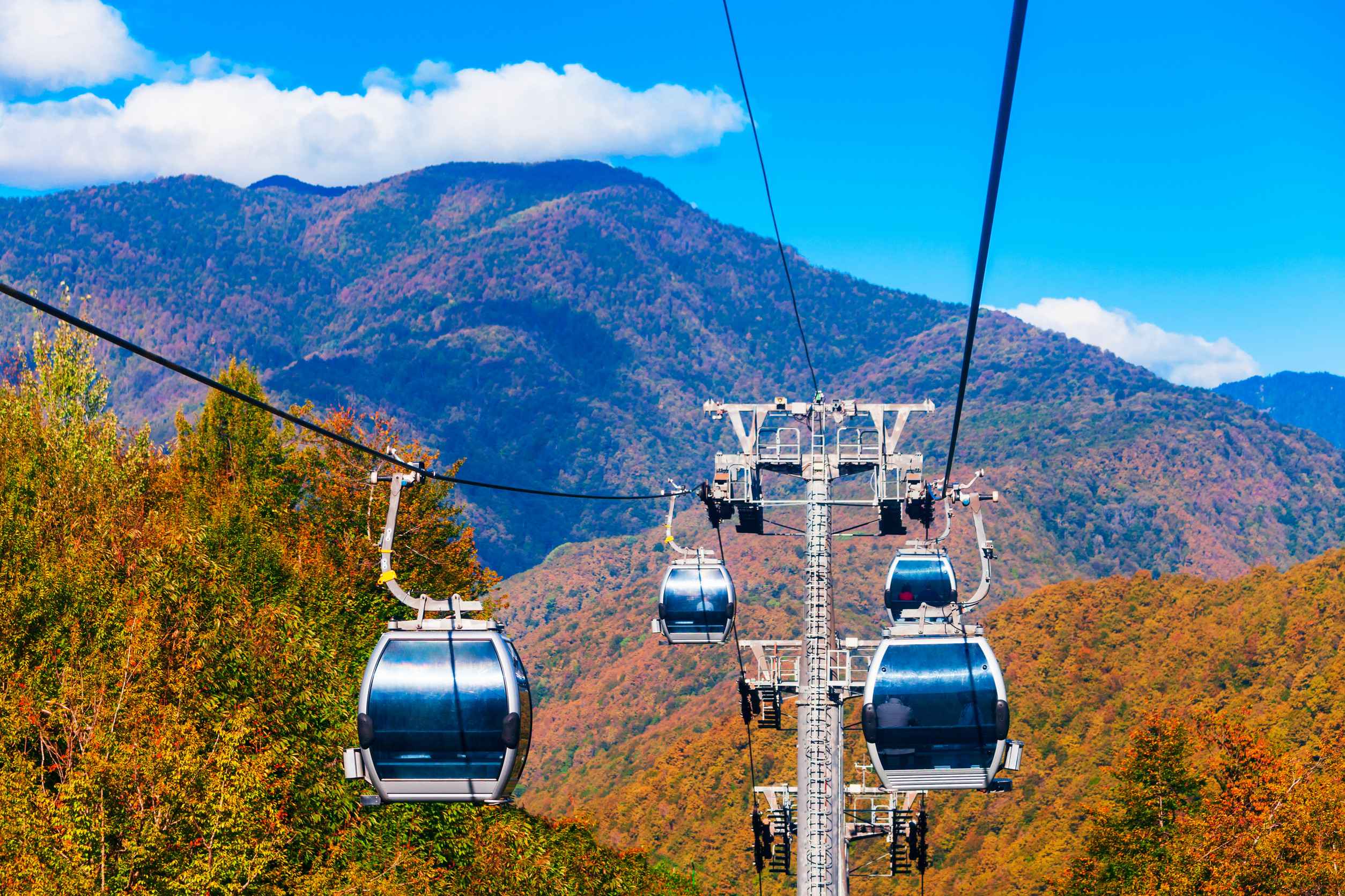 Cable car cabin rises up from Rosa Khutor village to Roza Peak mountain in Sochi resort city Cable car cabin rises up from Rosa Khutor village to Roza Peak mountain in Sochi resort city
