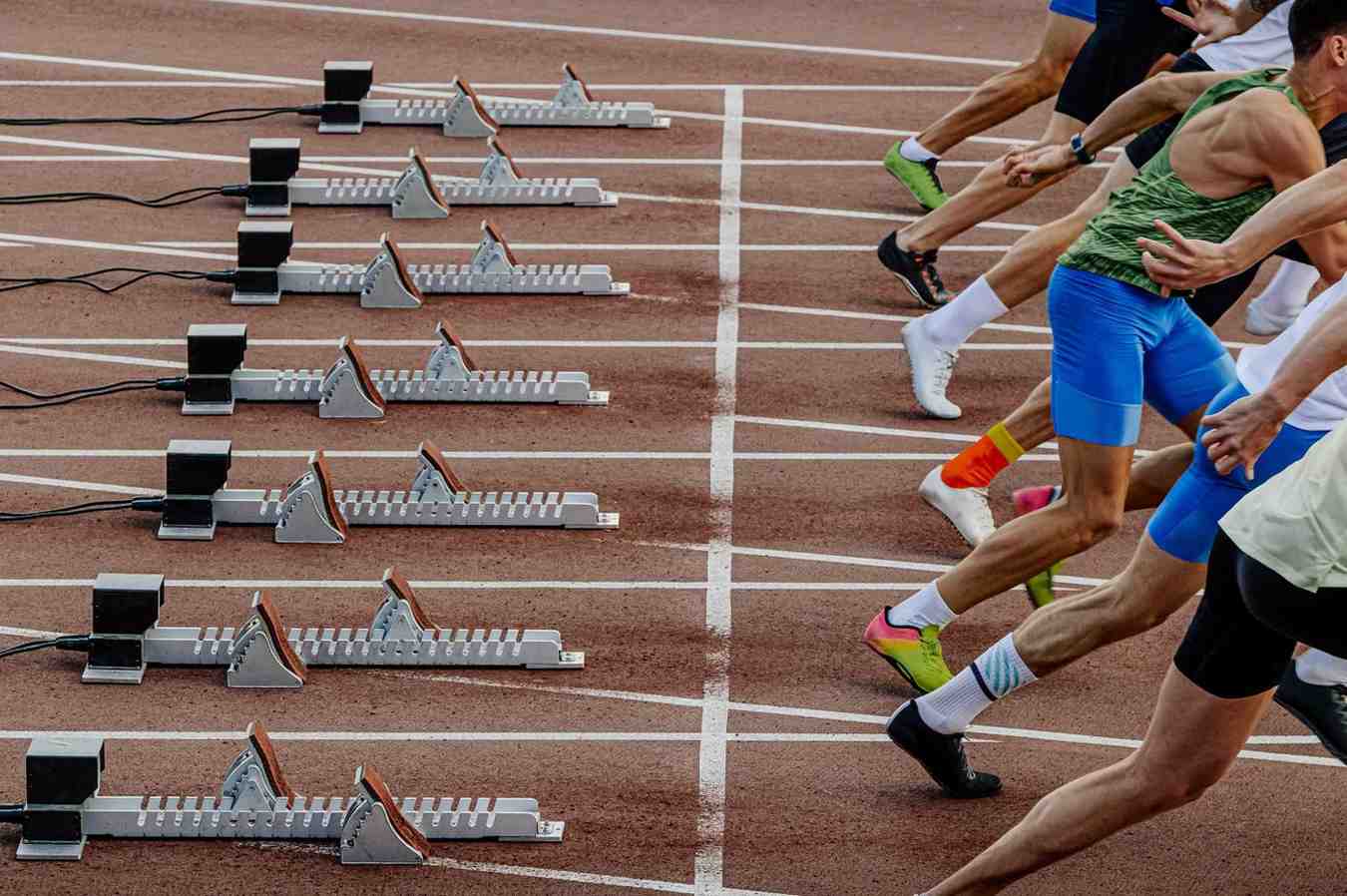 Male Runners Athletes Initiating A Race