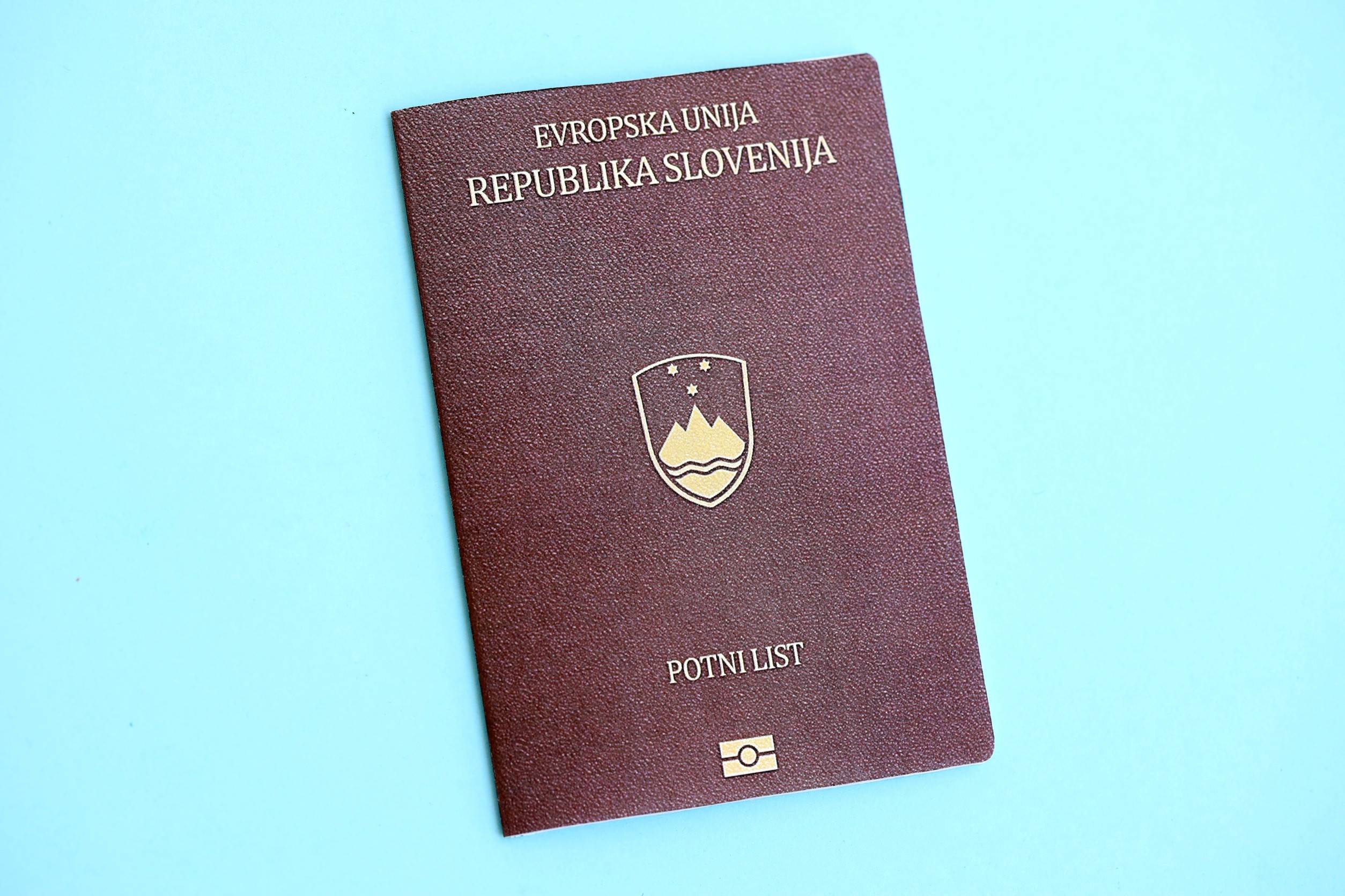 Slovenia Passport On Light Blue Paper Background