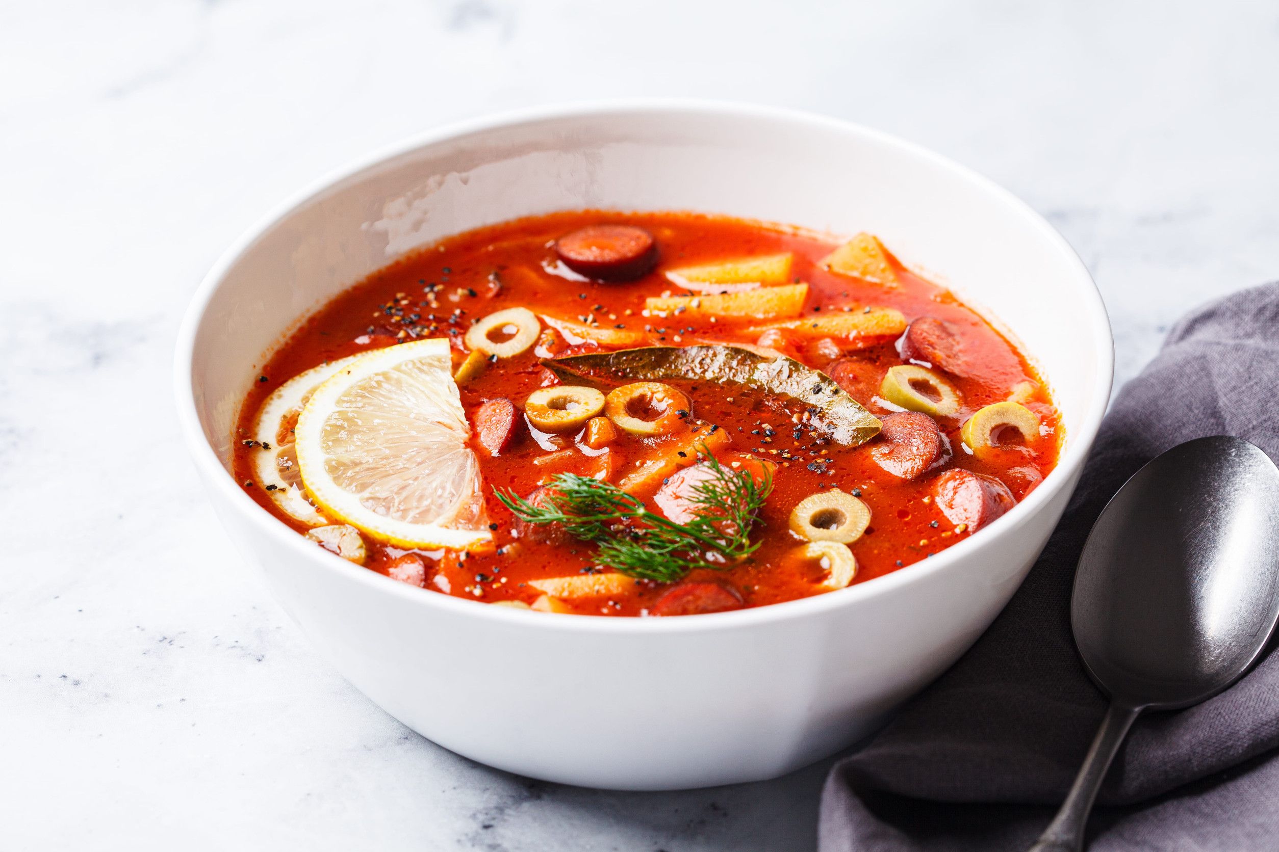 Tomato Soup Solyanka with olives in a bowl