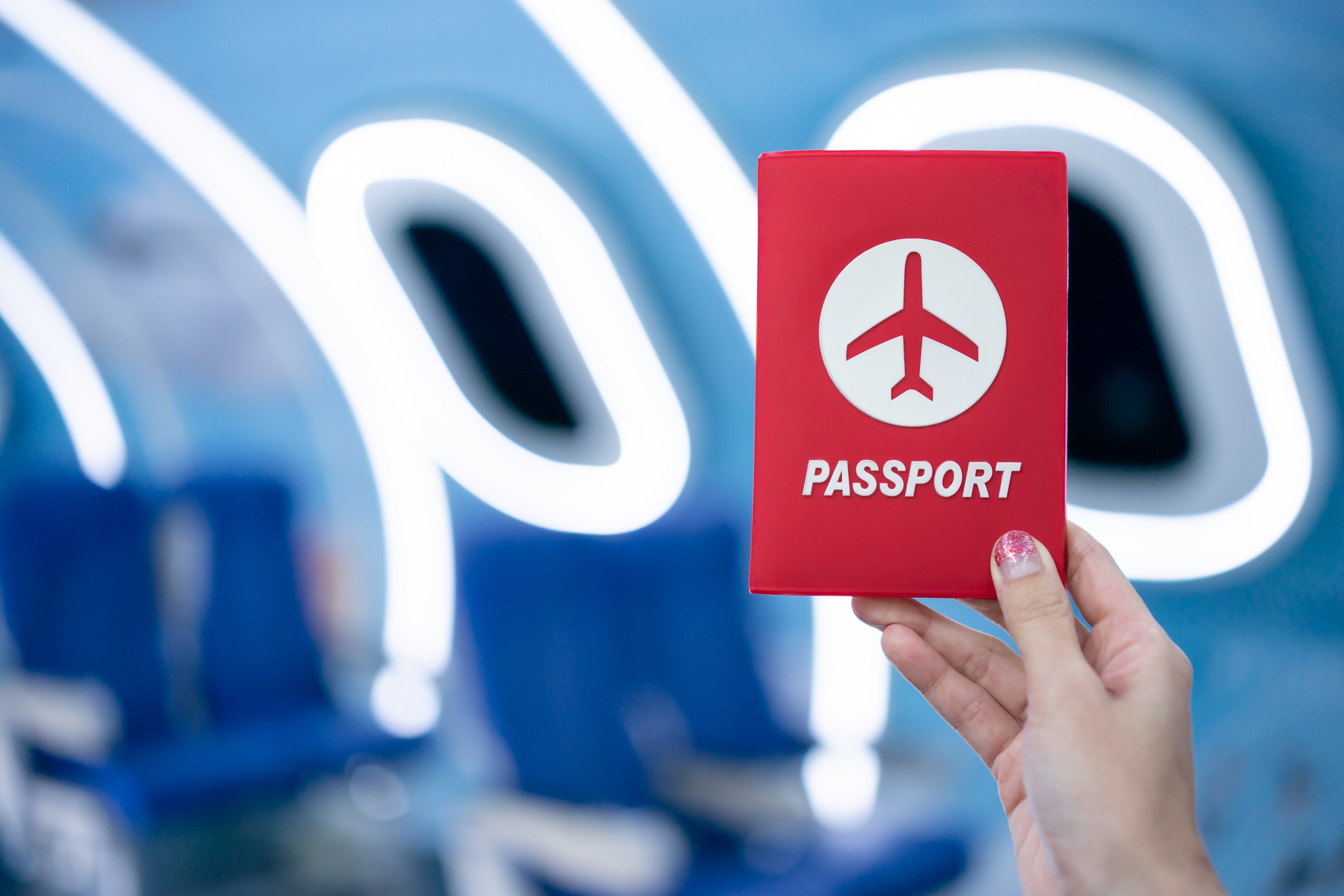 Woman hand showing passport inside airplane
